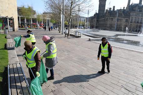 Students cleaning litter in city park