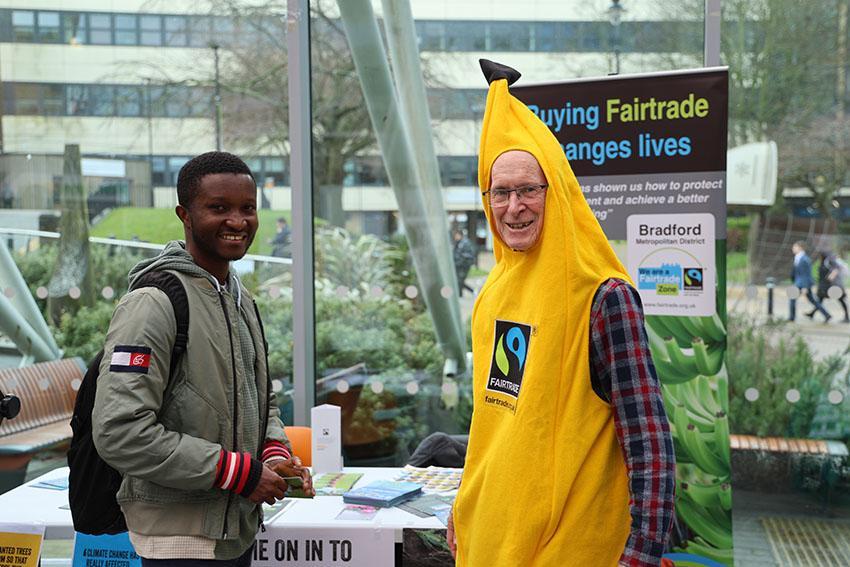 Student and Fairtrade representative in banana suit pose to promote Fairtrade