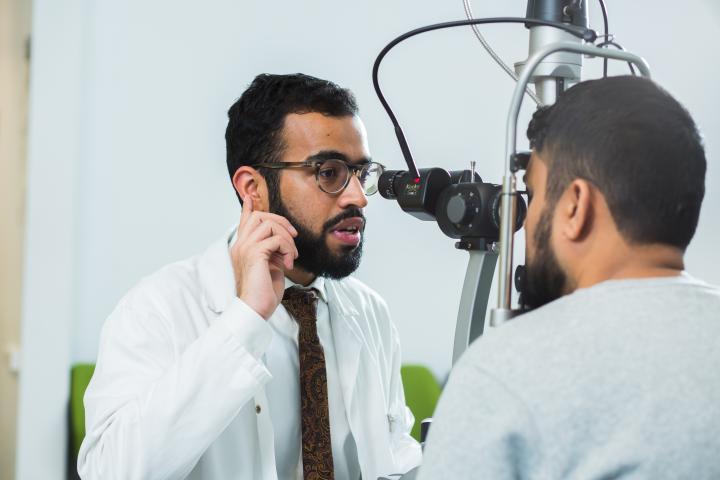 An optometry student carrying out an eye examination.
